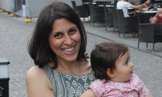 Nazanin smiling while holding her daughter, Gabriella