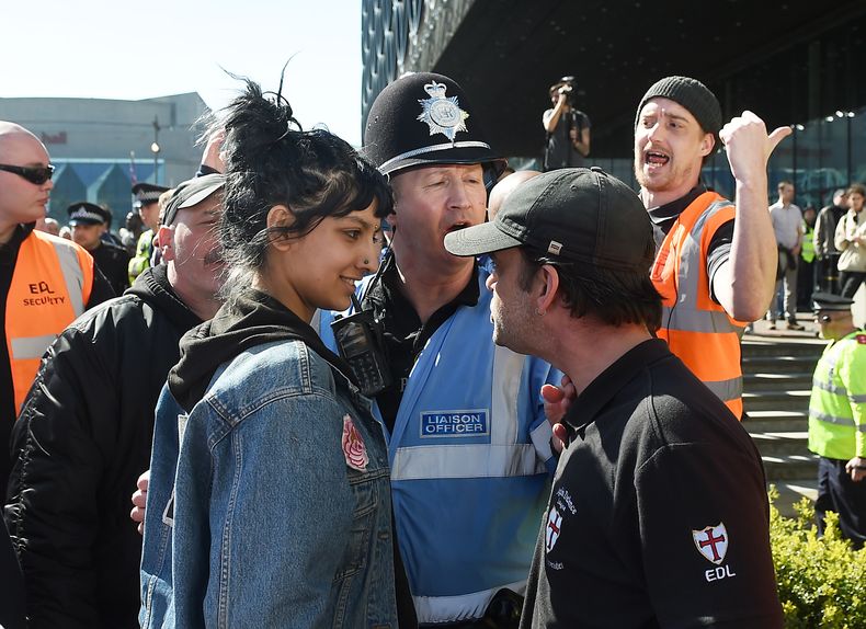 In a symbol of defiance, Saffiyah Khan (left) took a stand against English Defence League protester Ian Crossland in Birmingham in April 2017
