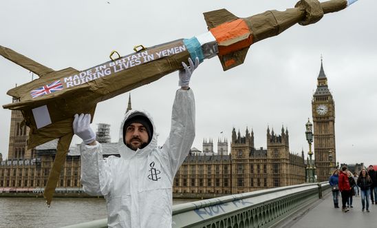 Amnesty International activists march with homemade replica missiles across Westminster Bridge