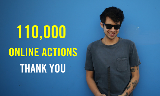 Image of Gustavo Gatica standing in front of a blue wall with '110,000 online actions thank you' text