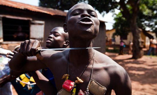 An Anti-balaka fighter holds a knife to his own throat