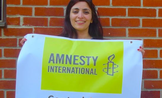Group member Behnaz holding up the group's petition for an ATT Group member Behnaz holding up the group's petition for an ATT