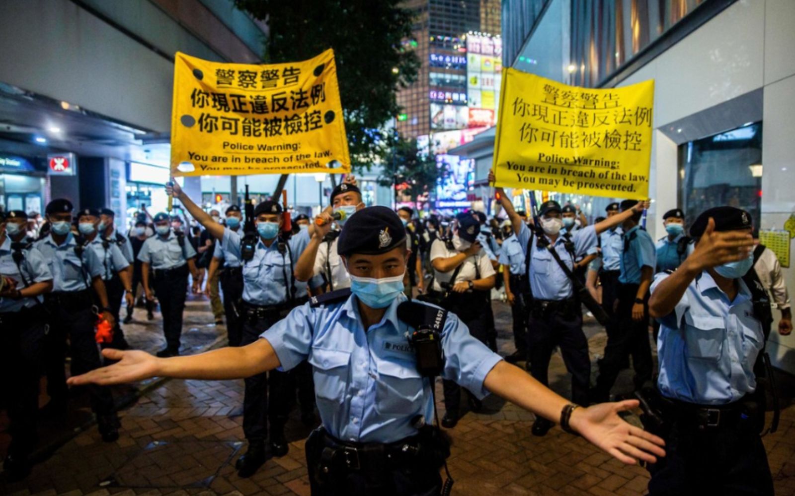 Protests in Hong Kong with security officers in front of them Protests in Hong Kong with security officers in front of them