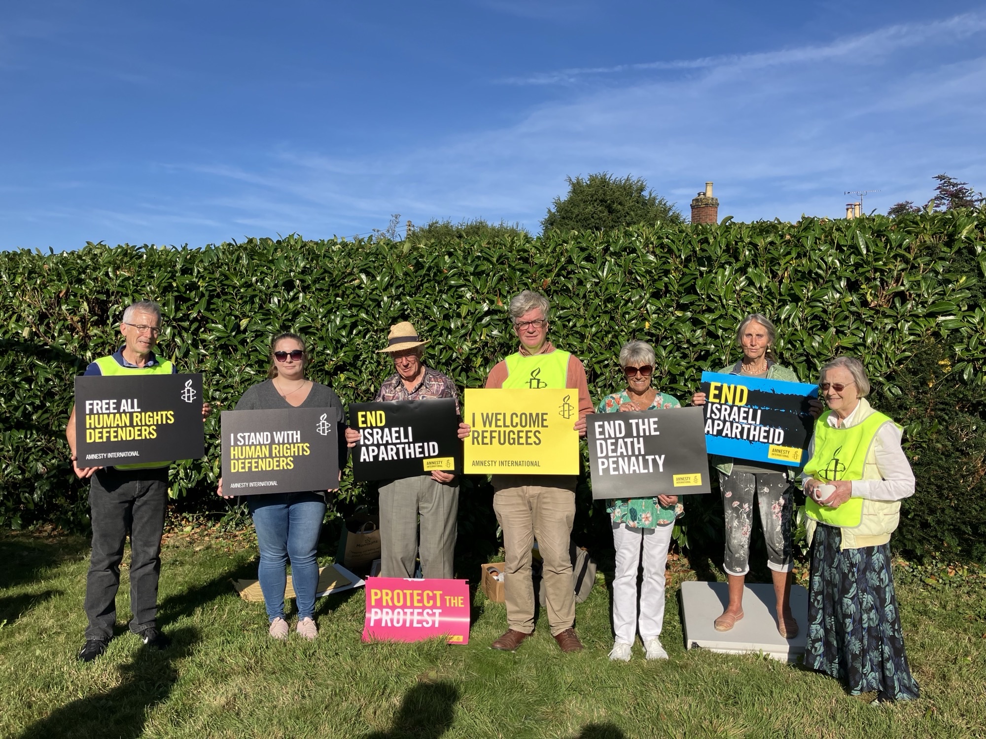 Members at the annual Garden Party with placards
