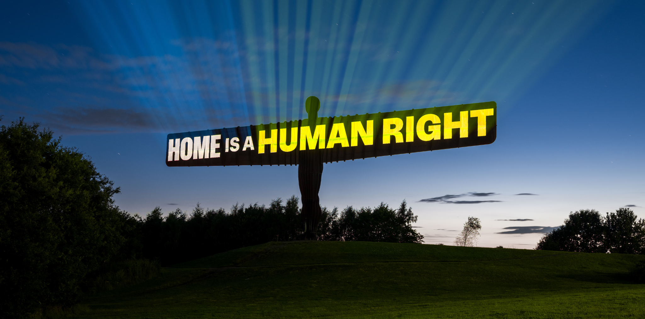 "home is a human right projected on angel of the north"