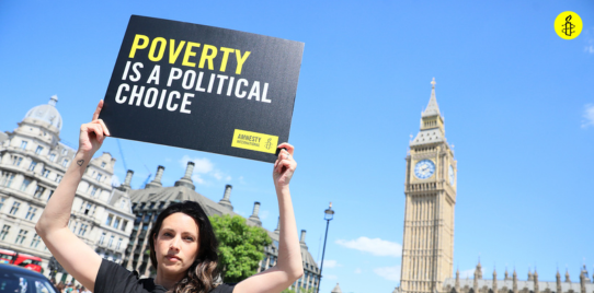 poverty is a political choice held up on a placard outside of westminster 