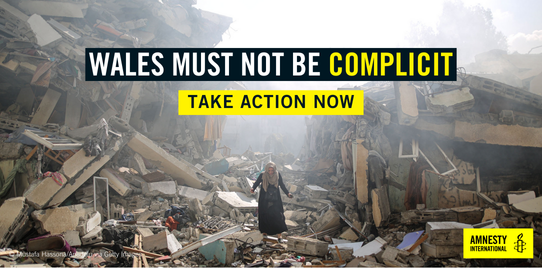 Image shows person walks amid near the rubble of residential buildings after Israeli airstrikes at al-Zahra neighborhood in Gaza Strip on October 19, 2023. Headline reads: Wales must not be complicit, take action now