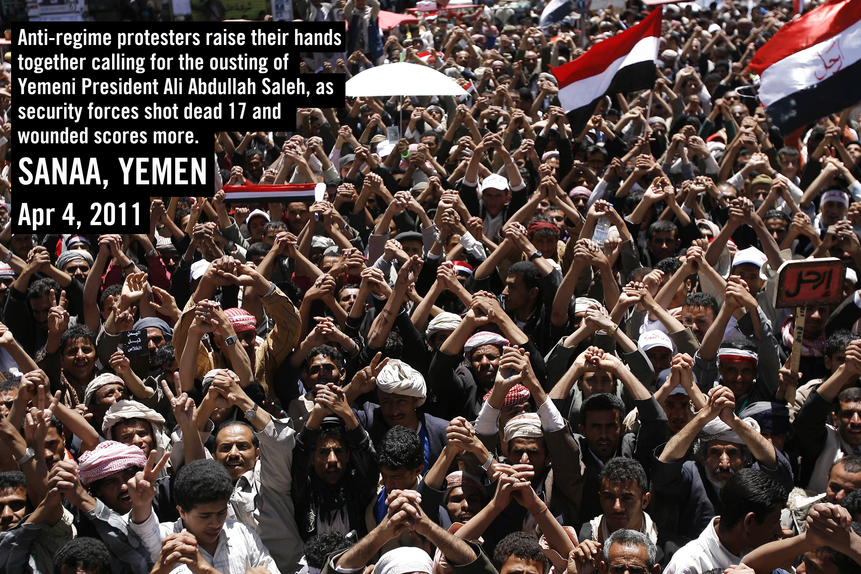 Anti-regime protesters raise their hands together during a demonstration