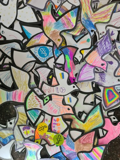 A collage of the Peace Doves coloured in by children at events in 2023 A collage of the Peace Doves coloured in by children at events in 2023