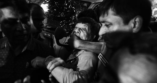 Shahidul Alam being taken away by police.