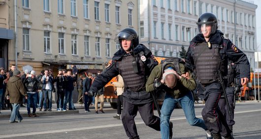 Riot police officers detain a protester during an unauthorised anti-corruption rally in central Moscow. Riot police officers detain a protester during an unauthorised anti-corruption rally in central Moscow.