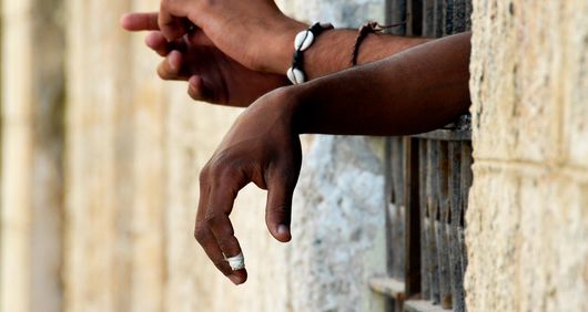 Hands reaching out from prison bars (c) John Woodworth Hands reaching out from prison bars (c) John Woodworth
