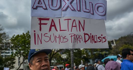A demonstrator at the protest “We don’t want to die” in Caracas, Venezuela carries a board denouncing the lack supplies and treatments for dialysis in Venezuela