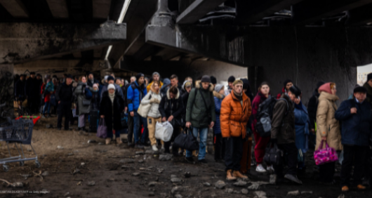 People stand beneath a bridge in Ukraine
