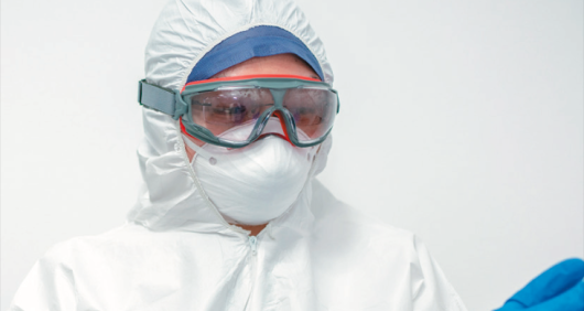 Healthcare worker puts on PPE in fight against coronavirus