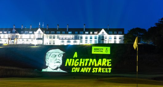 An Amnesty protest banner hung at one of his golf courses depicting President Trump alongside the words 'A nightmare on any street'