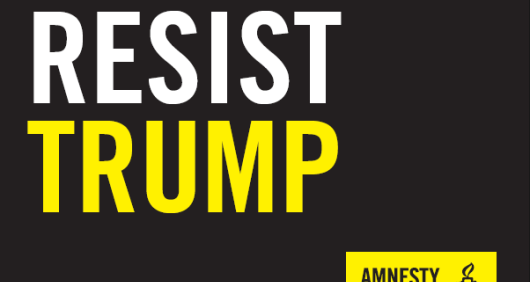 A black placard that reads 'Resist Trump' with an Amnesty logo in the bottom-right corner