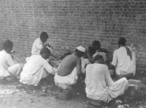 Pakistani prisoners breaking rocks in the prison yard