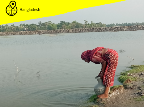 A woman drawing water from a river using a clay pot
