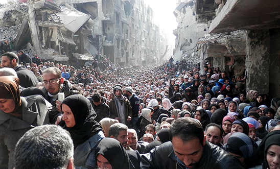 Yarmouk residents wait to receive food aid