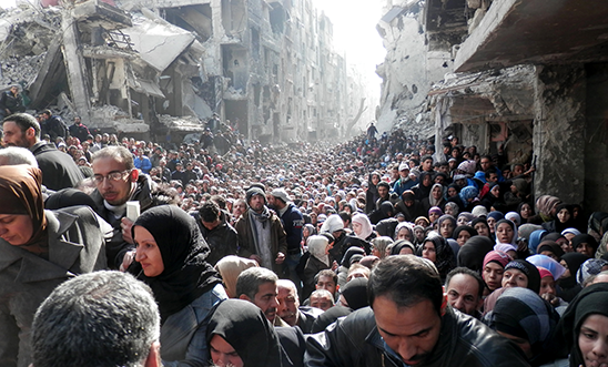 Yarmouk residents wait to receive food aid Yarmouk residents wait to receive food aid