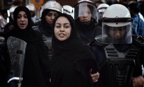 A Bahraini protester detained by riot police