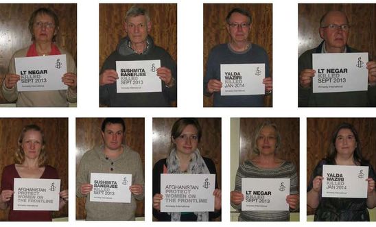 Holding up messages of support for Women's Rights in Afghanistan