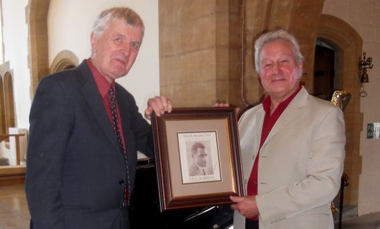 Keith Jones & Huw Morgan holding a picture of Paul Robeson