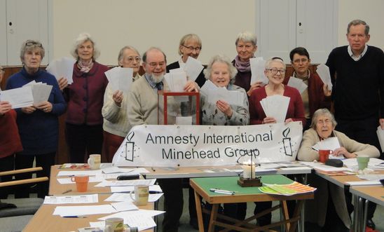 Amnesty members holding letters