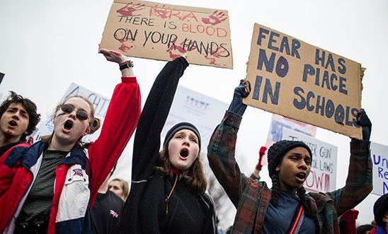 Young people with placards protesting for gun reform