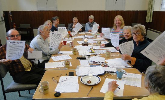 Members holding up urgent action case sheets Members holding up urgent action case sheets