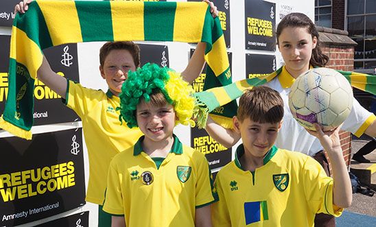 Pupils from Avenue Junior School, Norwich, wearing Norwich City colours