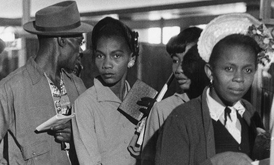 Immigrants to Britain from the West Indies queuing up on arrival at Southampton holding documents.