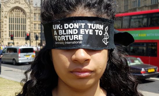 Blindfolded campaigners protest outside Parliament to call for a proper inquiry into UK torture involvement