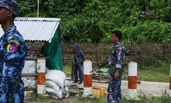 Myanmar border police stand guard at the check point near the entrance of Maungdaw township in Myanmar's Rakhine State