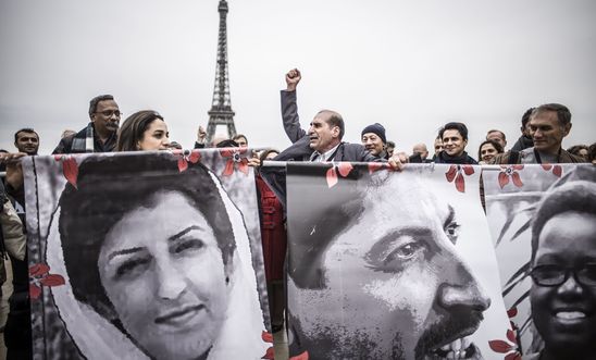 Activists gather outside the Palais de Chaillot for the closing ceremony of the Human Rights Defenders World Summit 2018