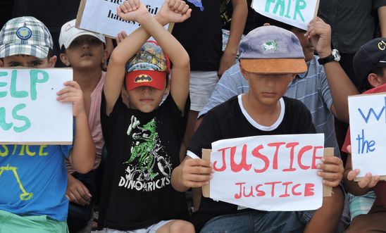 Refugee children take part in a protest in March 2015 against their resettlement on Nauru and living conditions on the island