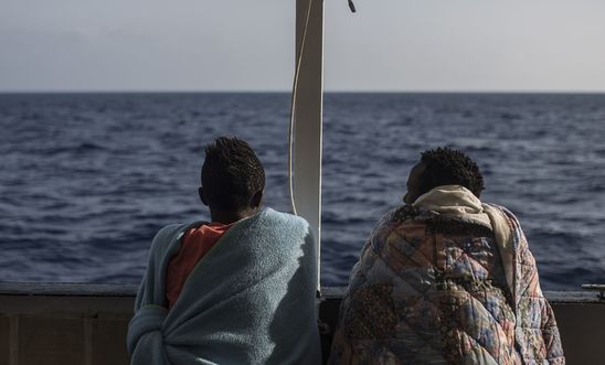 igrants look at the sea from the deck of the NGO Proactiva Open Arms boat on July 2, 2018