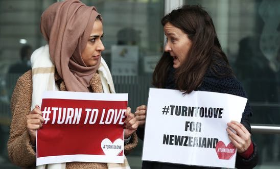 Members of Turn to Love hold placards outside New Zealand High Commission in Haymarket, London, following the mosque attacks in Christchurch.