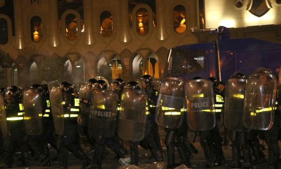 Police take security measurements as protesters gather outside Georgia's parliament