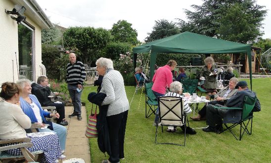 People drinking tea in a garden People drinking tea in a garden