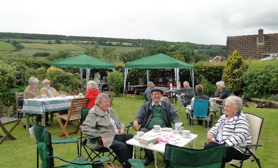 People drinking tea in a garden People drinking tea in a garden
