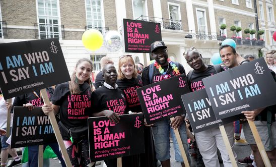 People from Amnesty International's Rainbow Network march at Pride in London. People from Amnesty International's Rainbow Network march at Pride in London.
