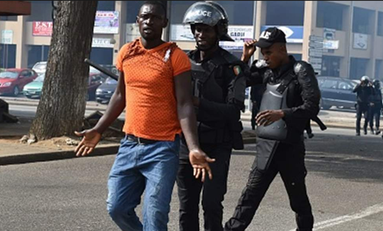 A man being arrested in Ivory Coast