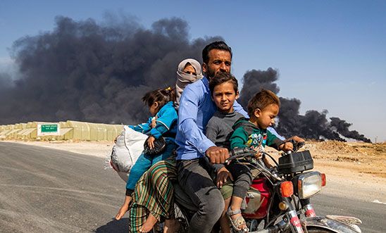 A Syrian family ride a bike