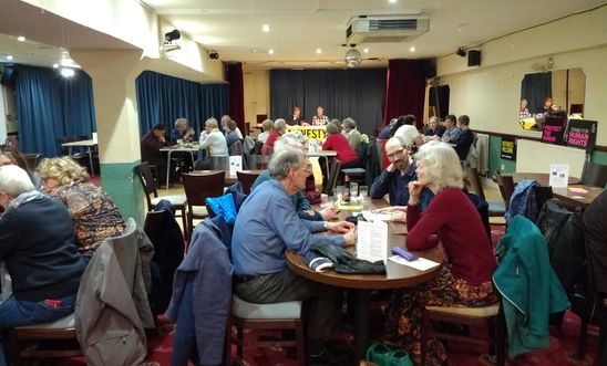 room full of people at a quiz room full of people at a quiz