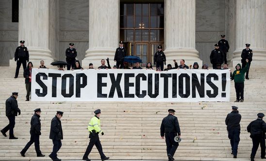 Police officers gather to remove activists during an anti death penalty protest in front of the US Supreme Court January 17, 2017 in Washington, DC