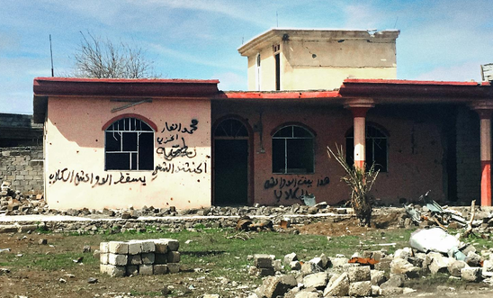 A house daubed with the words 'This is the home of Daesh dogs' in the town of Hammam al-Alil in Ninewa governorate