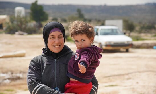 A Palestinian woman and her son in the village of Susiya, occupied West Bank, February 2020. Less than a kilometre away, lies the illegal Israeli settlement of Susya. 