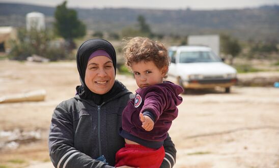 A Palestinian woman and her son in the village of Susiya, occupied West Bank, February 2020. Less than a kilometre away, lies the illegal Israeli settlement of Susya. A Palestinian woman and her son in the village of Susiya, occupied West Bank, February 2020. Less than a kilometre away, lies the illegal Israeli settlement of Susya.